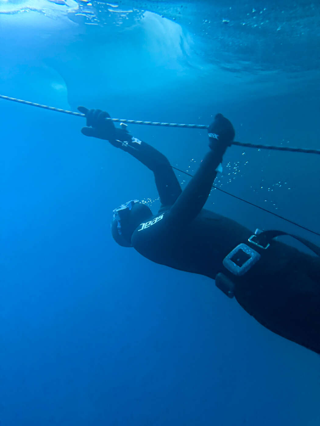 Divers beneath the frozen lake of Tignes